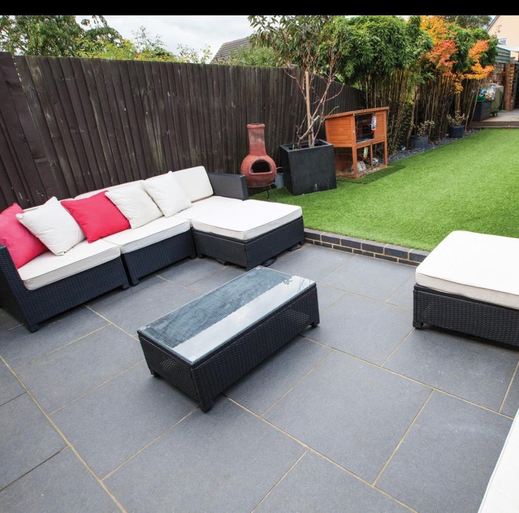 Dark grey porcelain patio with rattan sofa set and artificial grass, Surrey
