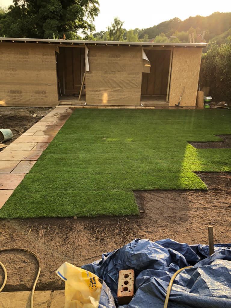 Garden room studio under construction with new turf lawn being laid, Surrey