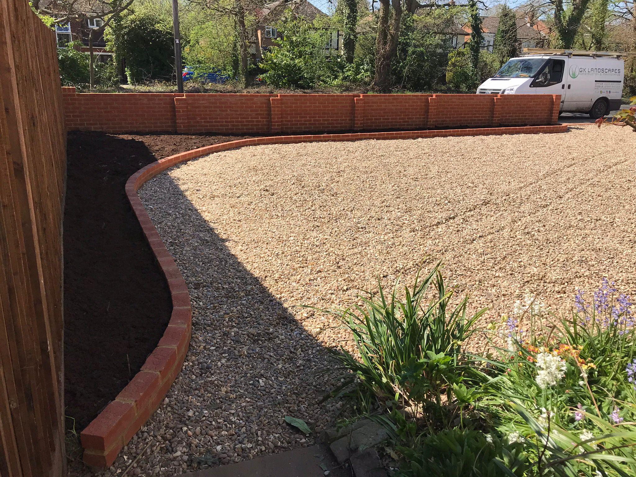 Gravel driveway with curved brick edging and retaining wall, Surrey