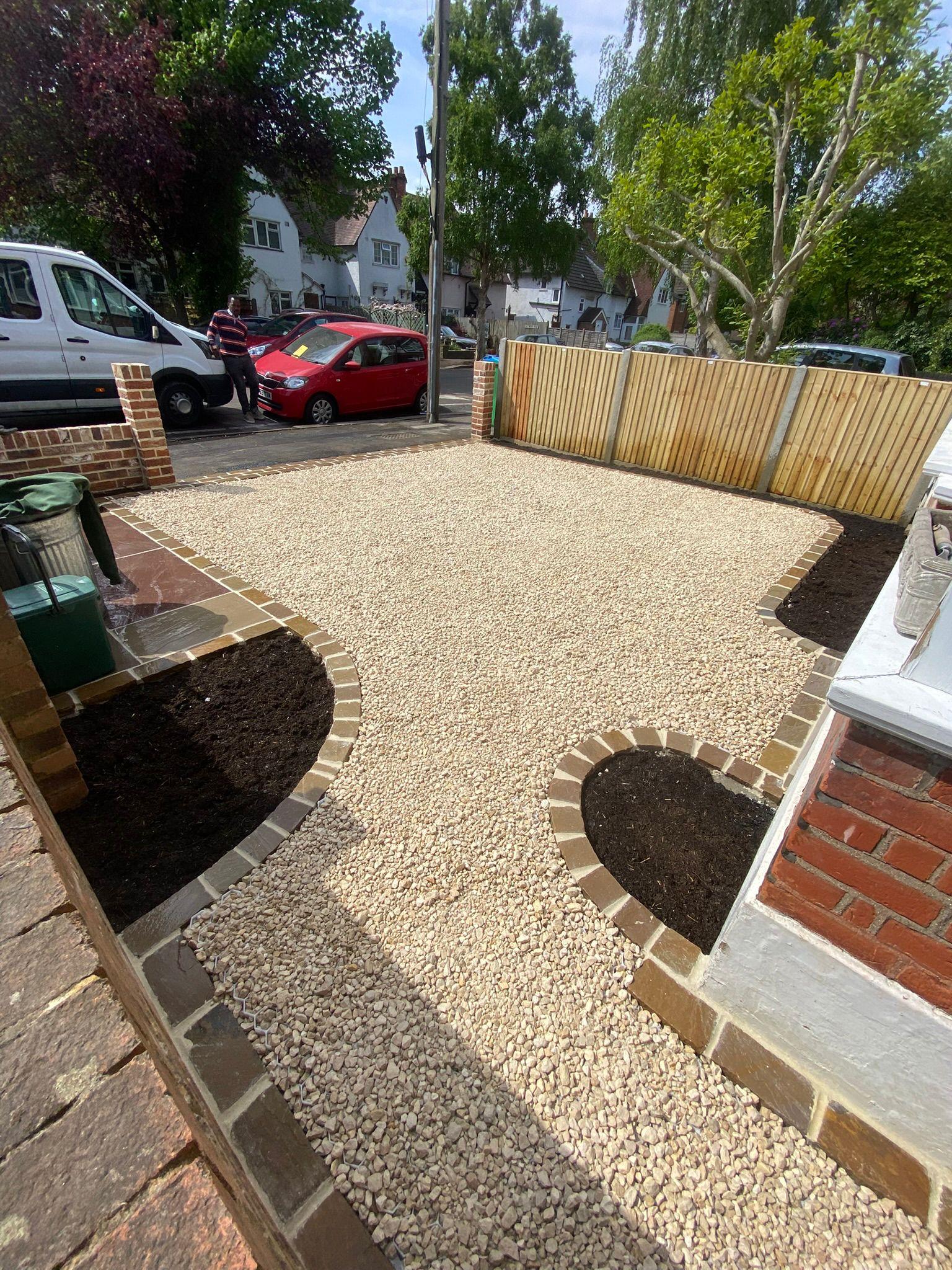 Gravel driveway with brick edging and planting bays, Surrey
