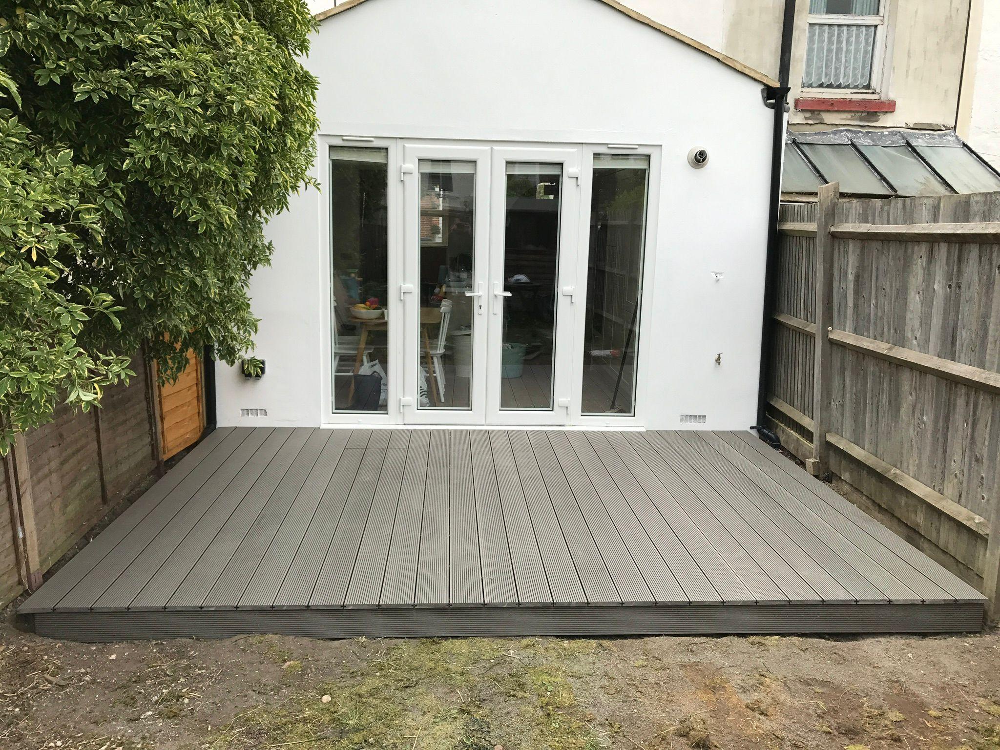 Grey composite decking with French doors at rear extension, Surrey