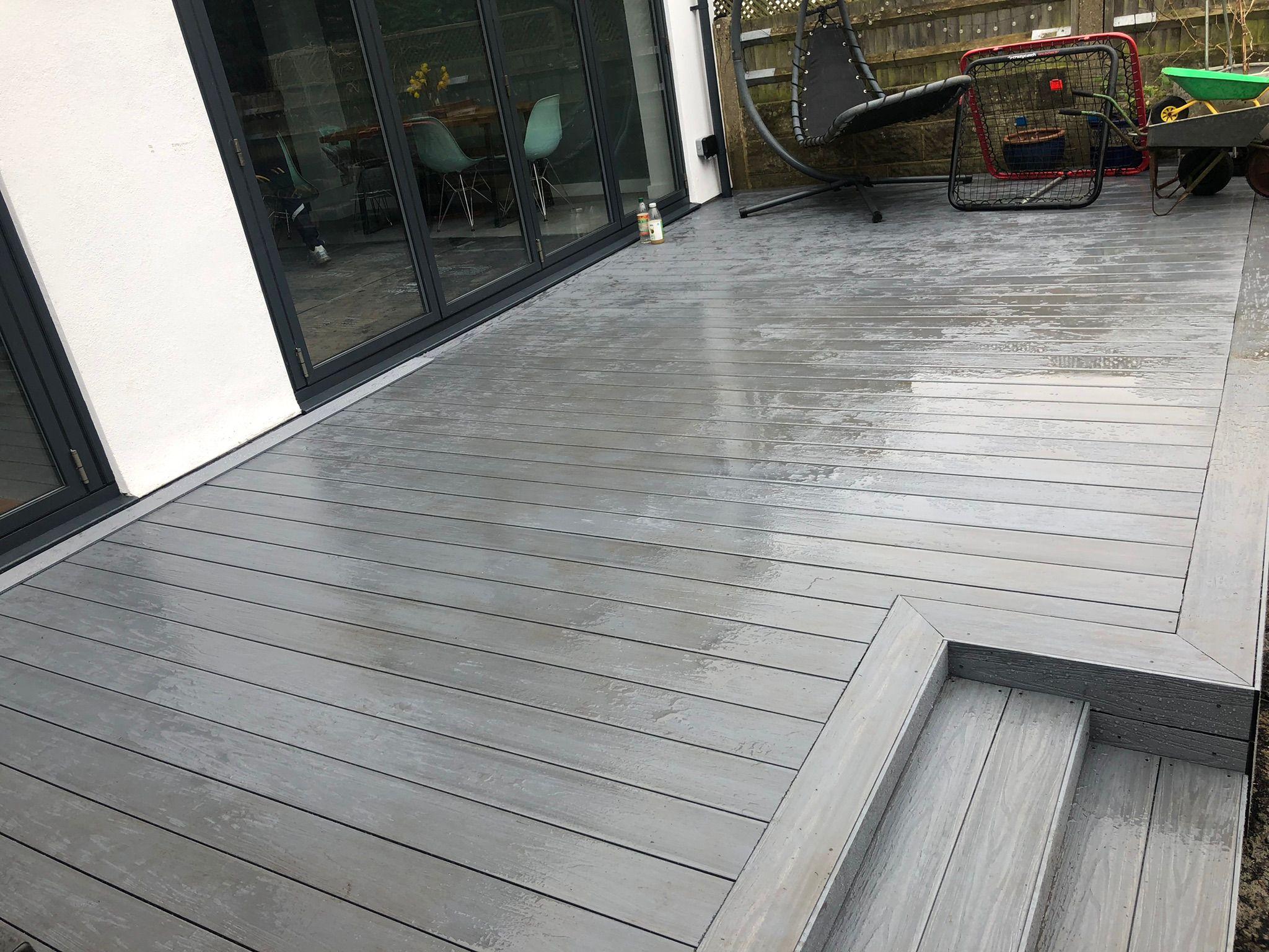Grey composite decking with steps and sliding doors, Surrey