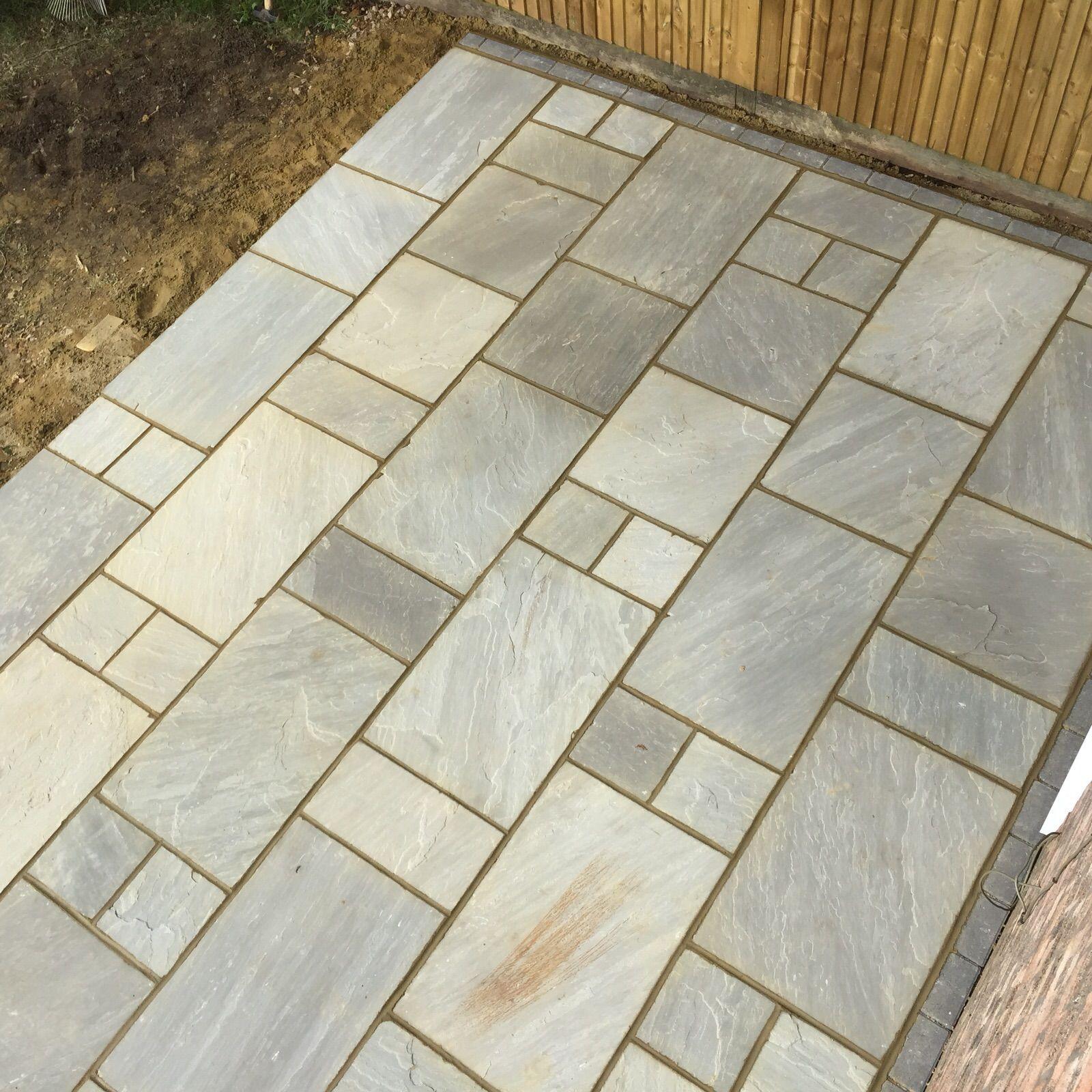 Natural sandstone patio close-up showing mixed size flags, Surrey