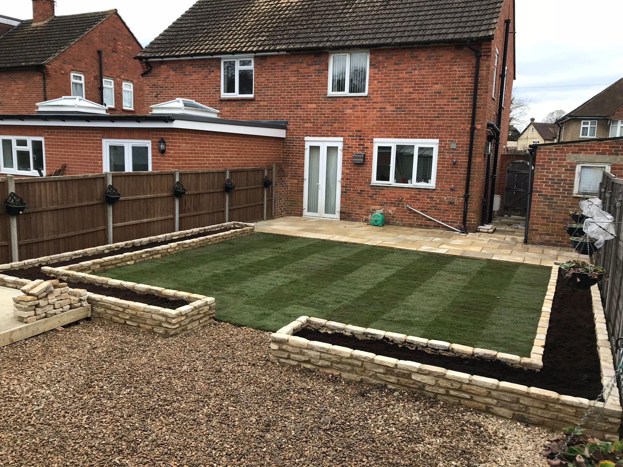 New turf lawn with sleeper raised beds and gravel patio, Surrey